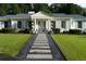 Charming front entrance with a stone walkway, manicured lawn, and a classic portico supported by elegant white columns at 4095 N Broadland Nw Rd, Atlanta, GA 30342