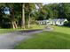 Beautiful home with winding driveway and lush green lawn showcasing a perfect blend of nature and curb appeal at 4095 N Broadland Nw Rd, Atlanta, GA 30342