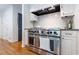 Gourmet kitchen features a stainless steel range and white cabinetry at 4095 N Broadland Nw Rd, Atlanta, GA 30342