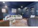 Sophisticated blue living room featuring a curved sofa and elegant decor at 4095 N Broadland Nw Rd, Atlanta, GA 30342