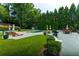 Inviting backyard pool with lounge chairs, dining and entertaining areas all surrounded by lush greenery at 4095 N Broadland Nw Rd, Atlanta, GA 30342