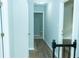 Hallway with luxury vinyl plank flooring and neutral paint leading to multiple rooms at 909 Ne Otter Way Ne Way, Marietta, GA 30068