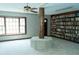 Cozy living room featuring a large window, ceiling fan and custom built-in wooden bookcase at 909 Ne Otter Way Ne Way, Marietta, GA 30068
