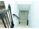 View of staircase leading down to the carpeted basement with a black iron railing at 909 Ne Otter Way Ne Way, Marietta, GA 30068