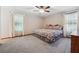 Bedroom features a ceiling fan, large window, neutral carpet, and a double bed at 1159 Midland Nw Dr, Acworth, GA 30102