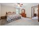 Large bedroom with ceiling fan, carpet, wooden furniture and doorway at 1159 Midland Nw Dr, Acworth, GA 30102