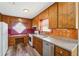 Functional kitchen featuring wooden cabinets, a stainless steel dishwasher, and plank floors at 1159 Midland Nw Dr, Acworth, GA 30102