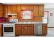 Well-maintained kitchen with wood cabinets, gas range, and stainless steel dishwasher at 1159 Midland Nw Dr, Acworth, GA 30102