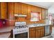 Traditional kitchen features wood cabinets, stainless steel sink, tile backsplash, and gas stove at 1159 Midland Nw Dr, Acworth, GA 30102