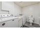 Laundry room featuring a washing machine, dryer, utility sink, and toilet at 1159 Midland Nw Dr, Acworth, GA 30102
