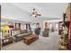 Open living room showcasing plush carpeting, a stone fireplace, and natural lighting at 1159 Midland Nw Dr, Acworth, GA 30102