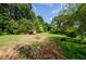 Open backyard space with green grass and shade trees at 123 Arnold Pl, Jonesboro, GA 30236