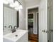 Bathroom featuring a white sink vanity and doorway views of the home's interior at 123 Arnold Pl, Jonesboro, GA 30236