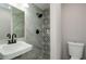 Modern bathroom features sleek fixtures, decorative tile accent wall, and a walk-in shower at 123 Arnold Pl, Jonesboro, GA 30236