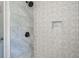 Shower featuring decorative tile design with a built-in niche and modern fixtures at 123 Arnold Pl, Jonesboro, GA 30236
