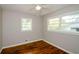 Bedroom featuring hardwood floors, neutral paint, ceiling fan, and large windows at 123 Arnold Pl, Jonesboro, GA 30236