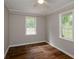 Bedroom featuring hardwood floors, neutral paint, ceiling fan, and large windows, for natural light at 123 Arnold Pl, Jonesboro, GA 30236