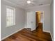Bedroom with hardwood floors, ceiling fan, and access to the hall, offers natural light at 123 Arnold Pl, Jonesboro, GA 30236