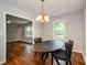 Well-lit dining area features hardwood floors and a chandelier at 123 Arnold Pl, Jonesboro, GA 30236