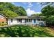 Charming ranch-style house with a well-manicured lawn and a bright blue front door at 123 Arnold Pl, Jonesboro, GA 30236