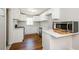 Modern kitchen with white cabinets, quartz countertops, and stainless steel appliances at 123 Arnold Pl, Jonesboro, GA 30236