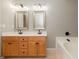 Bathroom boasts double sinks, wood cabinets, and a separate tub with dark accents at 2427 Camata, Marietta, GA 30066