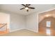 Bedroom with ceiling fan, neutral paint, and view of another room and a staircase at 2427 Camata, Marietta, GA 30066