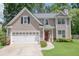 Charming two-story home with a well-manicured lawn and a two-car garage in a suburban neighborhood at 2427 Camata, Marietta, GA 30066
