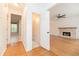 Hallway leads to a living room featuring gleaming hardwood floors and a cozy fireplace at 2427 Camata, Marietta, GA 30066