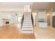 Open-concept living room featuring stairs to the second floor and a stone fireplace at 2427 Camata, Marietta, GA 30066