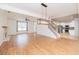 Spacious living room with hardwood floors, modern lighting, a staircase, and partial view of the kitchen at 2427 Camata, Marietta, GA 30066