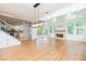 Open living area with hardwood floors, modern lighting, and a fireplace, seamlessly connecting to kitchen at 2427 Camata, Marietta, GA 30066
