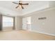 Main bedroom featuring a tray ceiling, fan, and window with coverings at 2427 Camata, Marietta, GA 30066