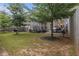 Backyard featuring a well-maintained lawn, trees, outdoor seating, and privacy fence at 3931 Fireoak Dr, Decatur, GA 30032