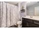 Well-maintained bathroom features a vanity with storage, a toilet, and a shower with a decorative curtain at 3931 Fireoak Dr, Decatur, GA 30032