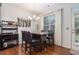 Cozy dining room with a modern chandelier, dark wood table, and a view of the backyard at 3931 Fireoak Dr, Decatur, GA 30032
