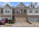 Charming townhomes with a brick and siding facade and attached two-car garages at 3931 Fireoak Dr, Decatur, GA 30032