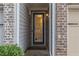 Close-up of the home's front door with glass detailing and brick and siding entryway at 3931 Fireoak Dr, Decatur, GA 30032