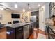 Modern kitchen with granite countertops, stainless steel appliances, and a central island overlooking the fireplace and living room at 3931 Fireoak Dr, Decatur, GA 30032
