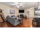 Inviting living room with a fireplace, large TV, hardwood floors, comfortable seating, and stairs leading to the upper level at 3931 Fireoak Dr, Decatur, GA 30032