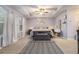 A spacious primary bedroom with a tray ceiling, ceiling fan, and neutral color palette at 3931 Fireoak Dr, Decatur, GA 30032