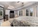Bedroom features a large bed, dresser, ceiling fan, and natural light from multiple windows at 3931 Fireoak Dr, Decatur, GA 30032