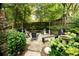 Lush backyard featuring a fire pit area, garden landscaping, and ambient lighting at 796 Piedmont Ne Way, Atlanta, GA 30324