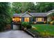 Charming home featuring manicured lawn, a stone retaining wall, and a cute covered front porch at 796 Piedmont Ne Way, Atlanta, GA 30324