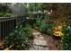 Stone pathway flanked by manicured landscaping and subtle lighting along the side of the home at 796 Piedmont Ne Way, Atlanta, GA 30324