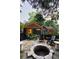 Inviting stone patio with a fire pit, comfortable seating, and lush landscaping for outdoor relaxation and entertainment at 796 Piedmont Ne Way, Atlanta, GA 30324