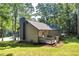 Backyard featuring a deck, chimney, lush green grass, and trees at 90 Lake Avalon Ct, Dallas, GA 30157