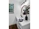 Bathroom showcasing a round mirror, black fixtures and white countertop and cabinets at 90 Lake Avalon Ct, Dallas, GA 30157