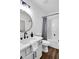 Bright bathroom featuring a stylish vanity, a round mirror and a bathtub with shower at 90 Lake Avalon Ct, Dallas, GA 30157