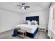Luxurious bedroom featuring plush carpeting, tray ceiling, and stylish blue upholstered bed at 90 Lake Avalon Ct, Dallas, GA 30157